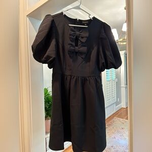 Black classic Sugarlips dress with bow detail. NWT size Medium